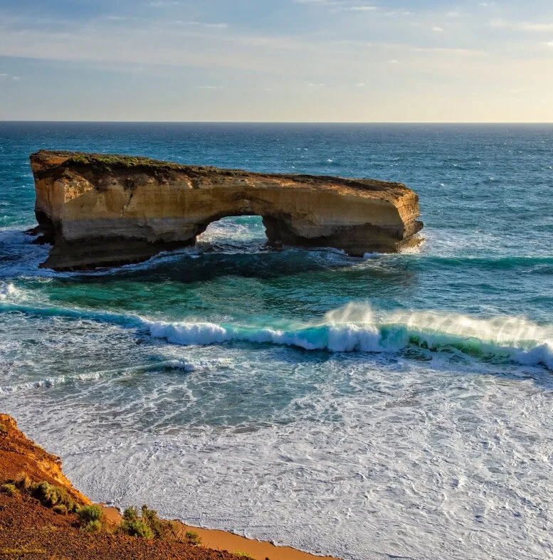 London Bridge standing in the ocean with turquoise waves breaking in front