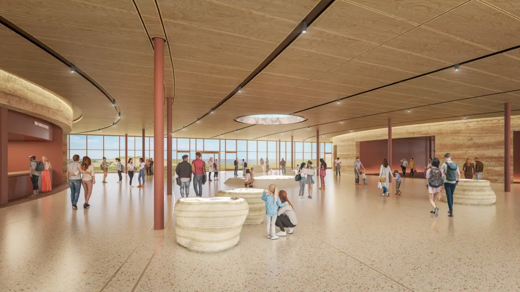 Artist's impression of the Twelve Apostles visitor centre foyer, with a curved timber ceiling, rammed earth walls and floor-to-ceiling windows looking out to the coast, as families explore interpretive displays